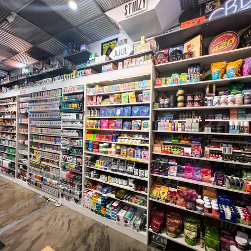 Floor-to-ceiling shelves of vapes, kratom, and accessories inside Smoke Club